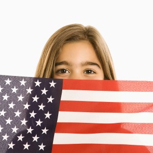 Girl holding American flag.